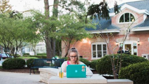 Student studying outside on central campus